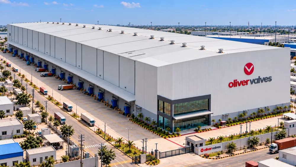 Aerial view of a large white warehouse with loading docks